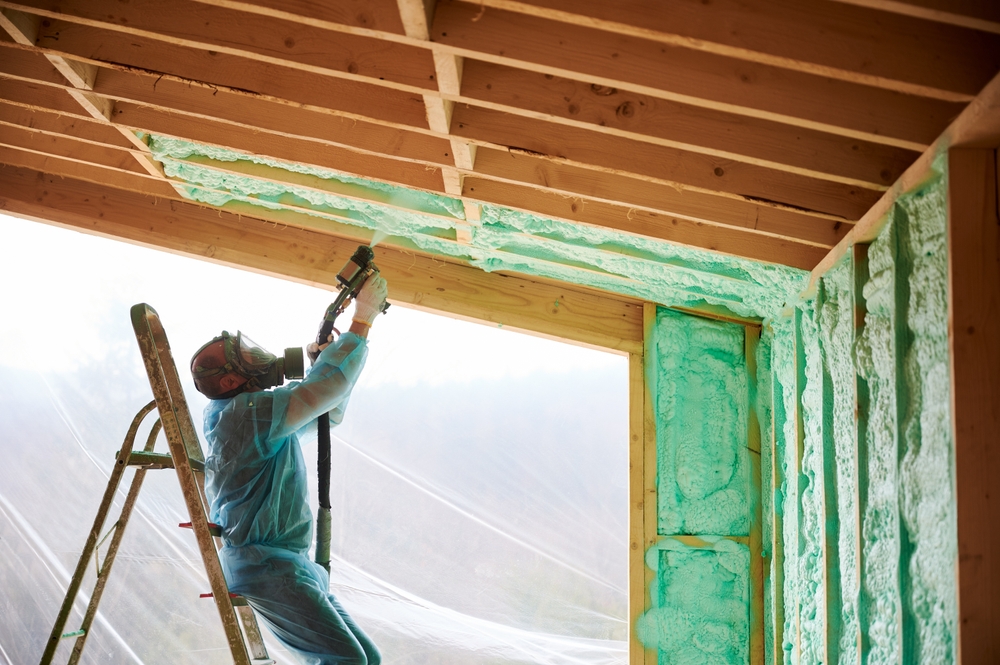 Male,Builder,Insulating,Wooden,Frame,House.,Man,Worker,Spraying,Polyurethane