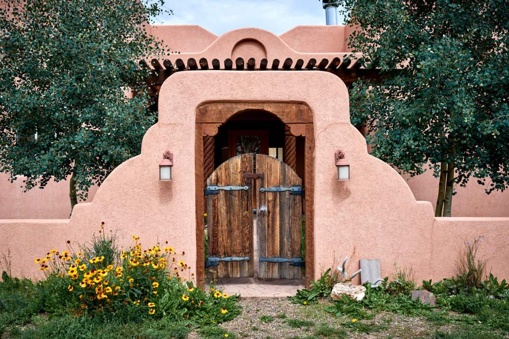 An,Adobe,Building,With,A,Wooden,Gate,And,Wall